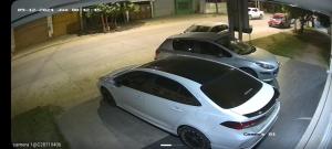 a white car parked in a parking lot at ALOJAMIENTO NORTE SGO in Santiago del Estero