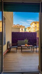 a balcony with two benches and a couch on a building at Real Rooms in La Spezia