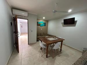 a living room with a table and a couch at ALOJAMIENTO NORTE SGO in Santiago del Estero +4 photos