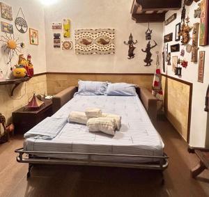 a large bed in a room with some pictures on the wall at Casa Claudia Stagnone in Marsala