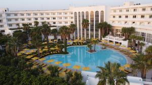 an overhead view of a hotel pool with chairs and palm trees at LAICO Hammamet hotel in Hammamet