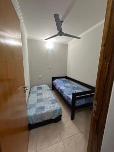 a bedroom with two beds and a ceiling fan at ALOJAMIENTO NORTE SGO in Santiago del Estero