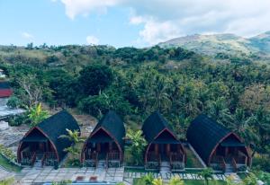 an aerial view of a resort with mountains in the background at The Southeast Penida in Polilit