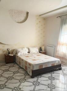 a bedroom with a large bed in a room at Apartment - Jijel in Jijel
