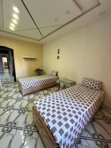 a room with two beds in a room at Apartment - Jijel in Jijel +5 photos