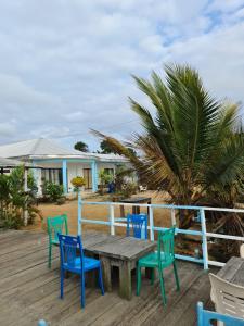 a wooden table and chairs on a deck at BEAUSÉJOUR Plage in Kribi
