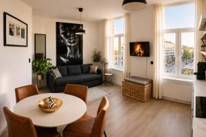 a living room with a table and a couch at SLEEP INN ANTWERP - Short & Longterm rentals in Antwerp