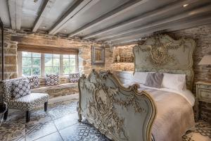 a bedroom with a king sized bed and a chair at Libertine in Breage +31 photos