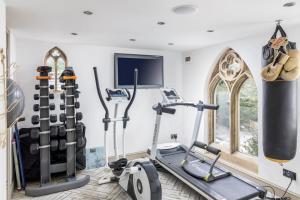a gym with two treadmills and two exercise bikes at Libertine in Breage