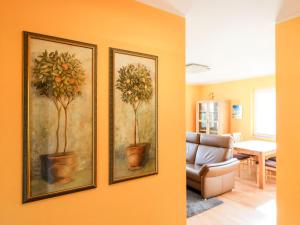 two paintings of plants on a wall in a living room at Gerlach in Zingst +4 photos
