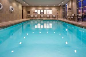 a large swimming pool with blue water at Crowne Plaza Anchorage-Midtown by IHG in Anchorage