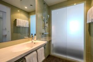 a bathroom with a sink and a shower at Premier Inn Hamburg City Berliner Tor in Hamburg