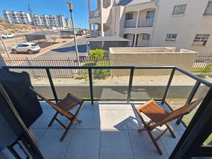 two chairs sitting on top of a balcony at 19 on Arch in Langebaan