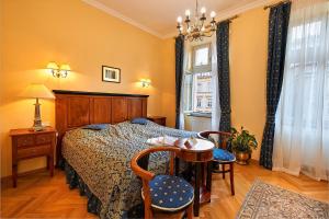 a bedroom with a bed and a table and chairs at Salvator Hotel in Karlovy Vary +36 photos