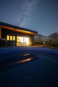 a small house at night with a view of the sky at Springsteen Cabins in Rawsonville
