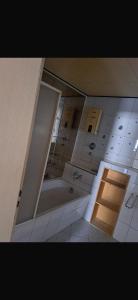a bathroom with a bath tub in a room at Ferienwohnung Reckerche in Reckershausen