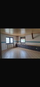 an empty room with two windows and a bed at Ferienwohnung Reckerche in Reckershausen