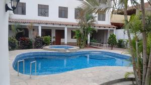 a swimming pool in front of a house at Modern Apartament Pool & Jacuzzi 2 room in Lima