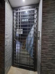 a dog in a cage in a building at ALOJAMIENTO NORTE 1 in Santiago del Estero