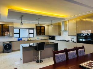 a large kitchen with a table and a counter top at Brooke Paradise in Bulawayo