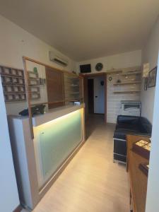 a large kitchen with a counter and a living room at Hotel Grotte in Mongiove