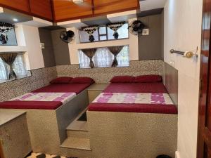 a room with two benches in a room with windows at Clintons Cove in Cochin