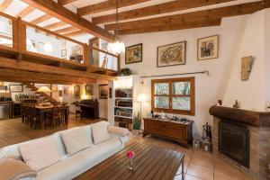 a living room with a couch and a fireplace at Fabulous Rustic Villa Set On Mountain With Unique Views in Valldemossa