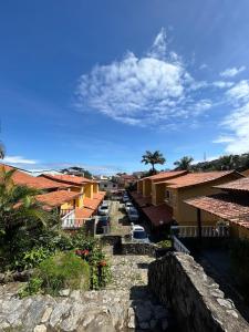 a view of a town with buildings and the ocean at Casas Arraial in Arraial do Cabo