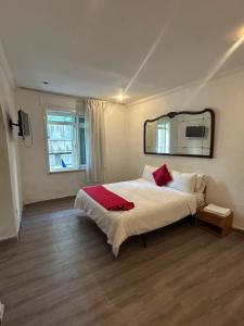 a bedroom with a large bed and a mirror at Hotel Astoria Tanger in Tangier