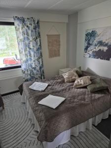 a bedroom with a bed with two towels on it at Koivutie Best rooms in Ranua