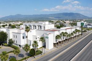 an aerial view of a white building with palm trees at Holiday Inn Monclova by IHG in Monclova