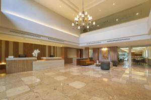 a lobby of a hotel with a chandelier at Holiday Inn Monclova by IHG in Monclova +84 photos