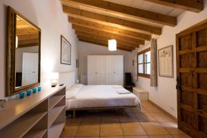 a bedroom with a bed and a large mirror at Fabulous Rustic Villa Set On Mountain With Unique Views in Valldemossa +85 photos