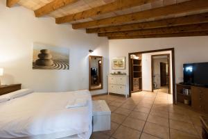 a bedroom with a bed and a flat screen tv at Fabulous Rustic Villa Set On Mountain With Unique Views in Valldemossa