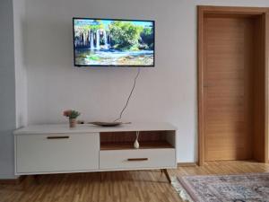 a living room with a white dresser with a tv on the wall at Ilidza Heart of the nature by Armin in Slivlje