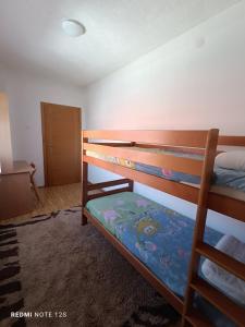 a bedroom with two bunk beds in a room at Ilidza Heart of the nature by Armin in Slivlje