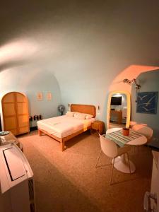 a bedroom with a bed and a table and chairs at Ca' Letizia in Noli