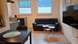 a living room with a couch and a table at Apartment 2 Unter den Eichen in Tätendorf-Eppensen