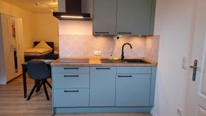 a kitchen with a sink and a counter top at Apartment 2 Unter den Eichen in Tätendorf-Eppensen