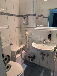 a bathroom with a sink and a toilet at Hotel Traumblick in Cochem +52 photos