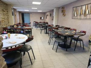 a row of tables and chairs in a restaurant at La Halte in Torigni-sur-Vire