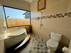 a bathroom with a sink and a toilet and a window at Ramantika Sunset Bay in Nusa Dua +17 photos