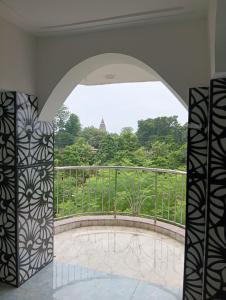 a room with a balcony with a view at Shahi House in Bodh Gaya