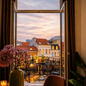 a balcony with a table and a view of a city at SLEEP INN ANTWERP - Short & Longterm rentals in Antwerp