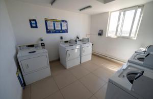 a bathroom with three washing machines and a sink at Suite moderna espacio parque in Calama +6 photos