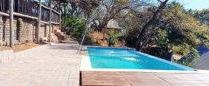 an empty swimming pool with a water hose at Risima Guest Lodge Hazyview in Numbi