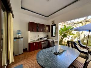a kitchen and a dining room with a table in a room at Ramantika Sunset Bay in Nusa Dua