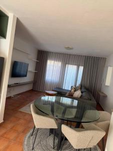 a living room with a glass table and a couch at Essie's Place in Windhoek
