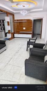a large living room with couches and a chandelier at Graps Ocean Stay in Chīrāla +4 photos