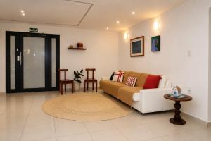 a living room with a couch and a table at Pousada Mangaba Sergipe in Aracaju